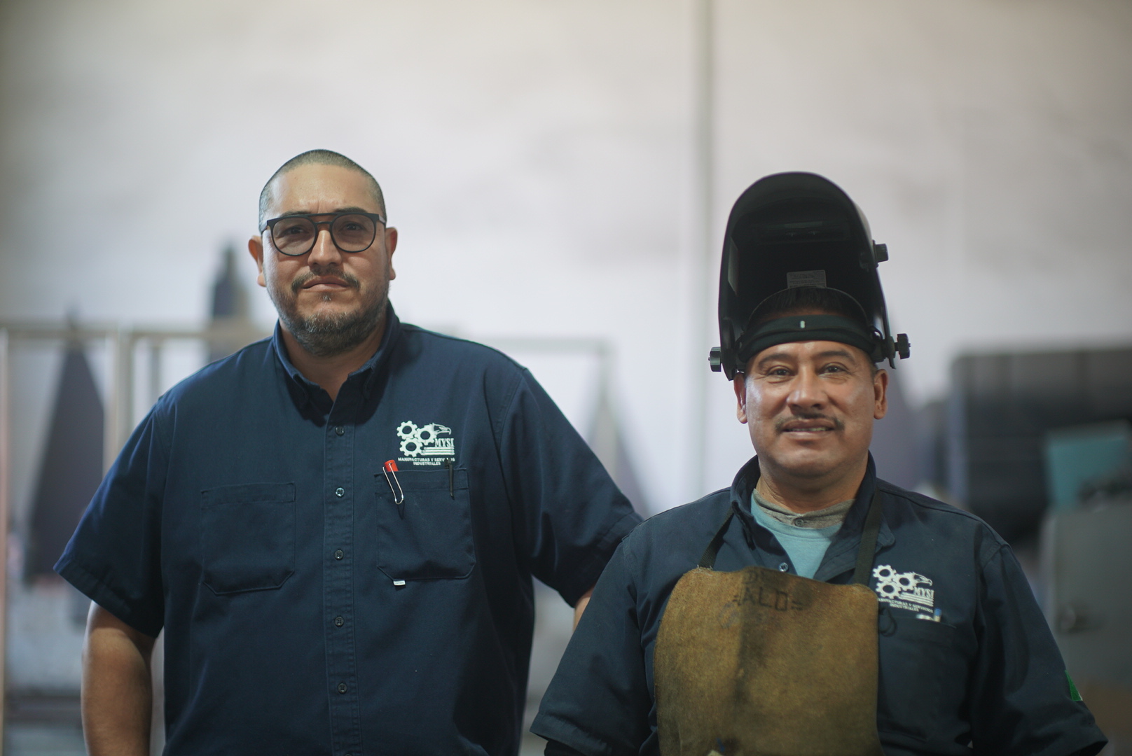 An industrial worker on the phone, providing support.